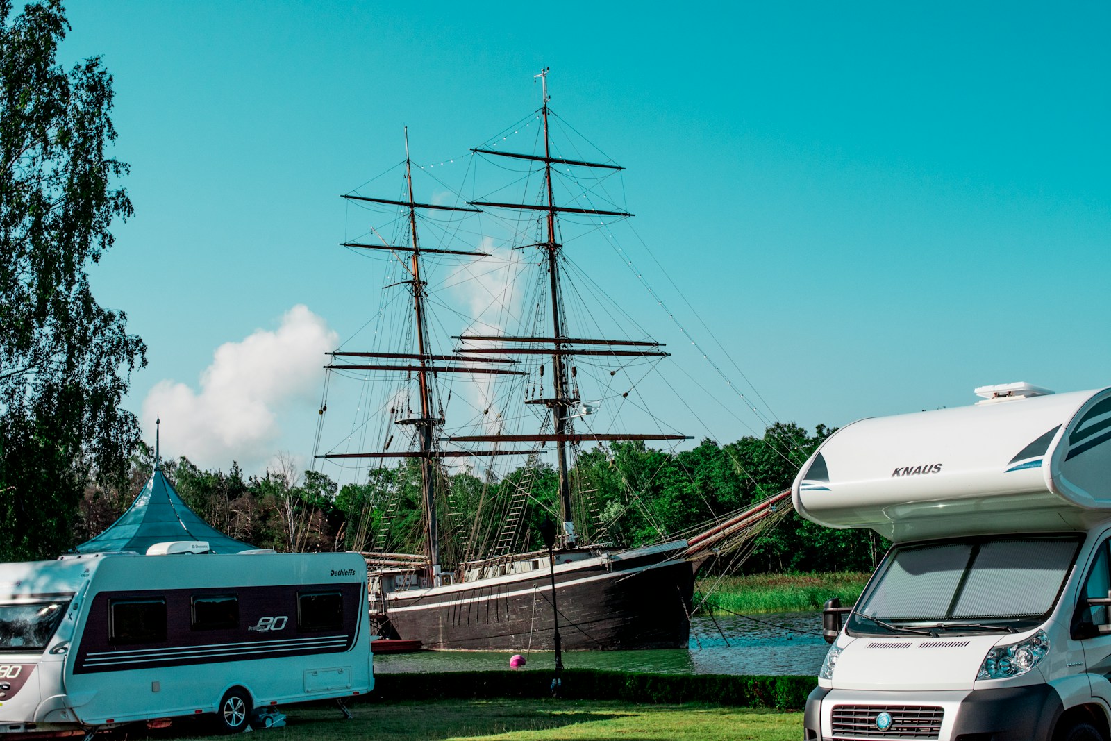 blue and white boat on dock during daytime RV and Boat Insurance